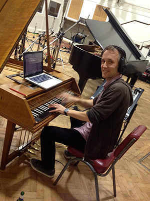 Conductor Andrew Skeet on harpsichord during <i>U.N.C.L.E.</i> session. (photo courtesy of Daniel Pemberton)