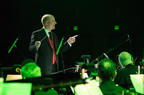 Conductor Steven Allen Fox leading a 32-piece orchestra