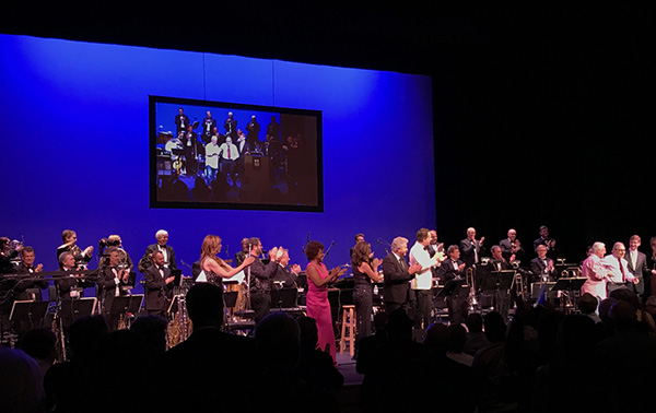 In front of orchestra (L to R): Sara Andon, Michael Giacchino, Sandra Booker, Denise Donatelli, Steve Tyrell, Chris Walden, Angel Romero, Lalo Schifrin, and Robert Townson